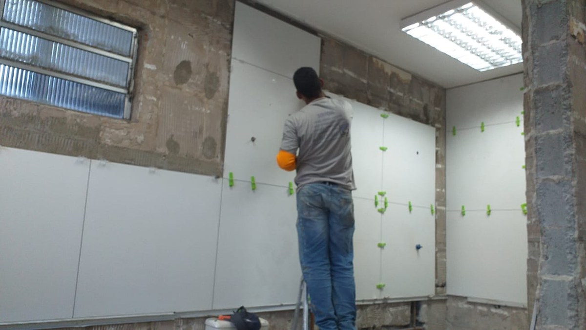 Profissional Barreto Prime instalando porcelanato com niveladores de precisão